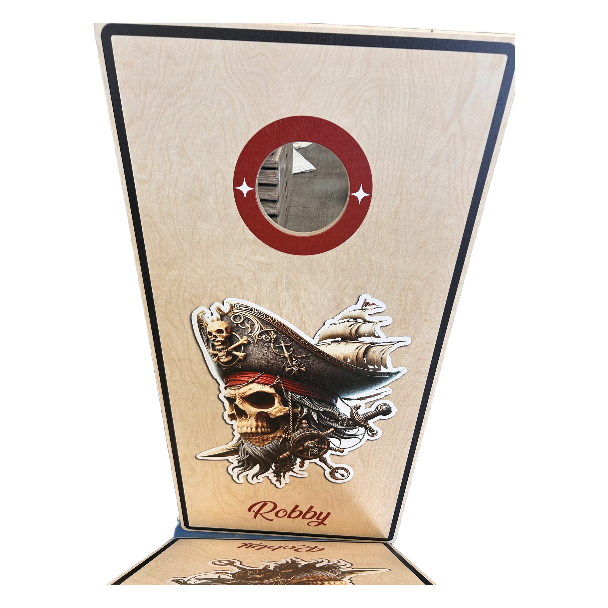 Tall wooden game board with a round central hole framed by a red ring and skull-and-sword stickers along the bottom edge.